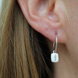 Earrings made by Sarah Smuts-Kennedy of Tāmaki Makaurau, Aotearoa