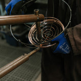Wire being welded to a steel frame. 