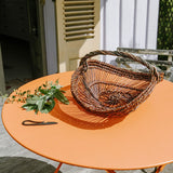 Perigord basket on orange table with herbs