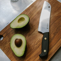 Rimu wooden chopping board with knife and avocado.